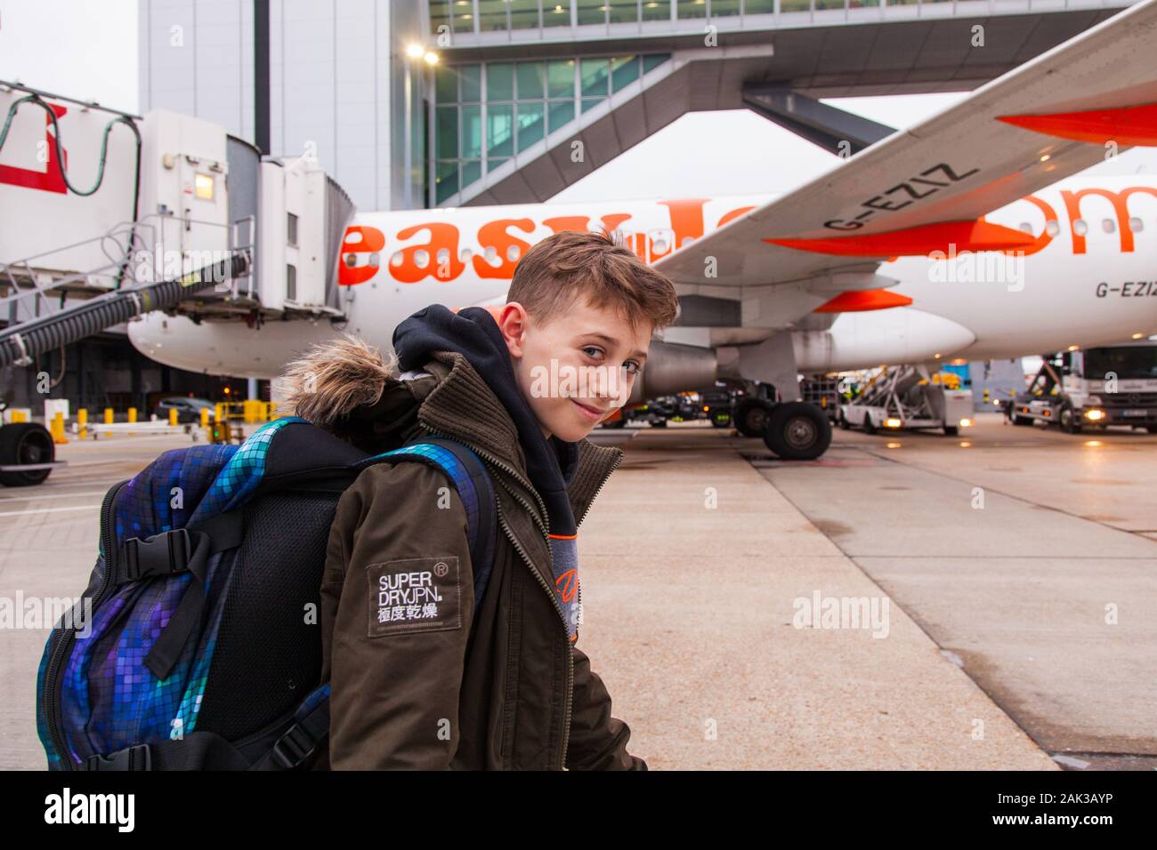 10 year old boy excitedly boarding a Easyjet flight at London Gatwick airport between London Gatwick LGW and Vienna Austria VIE Stock Photo