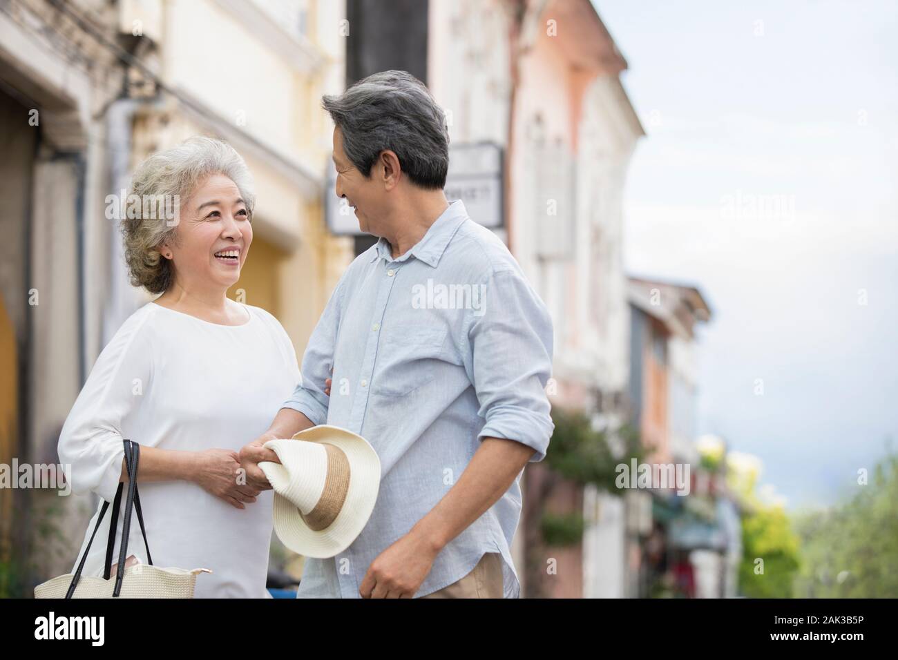 Happy senior Chinese couple standing on street Stock Photo - Alamy