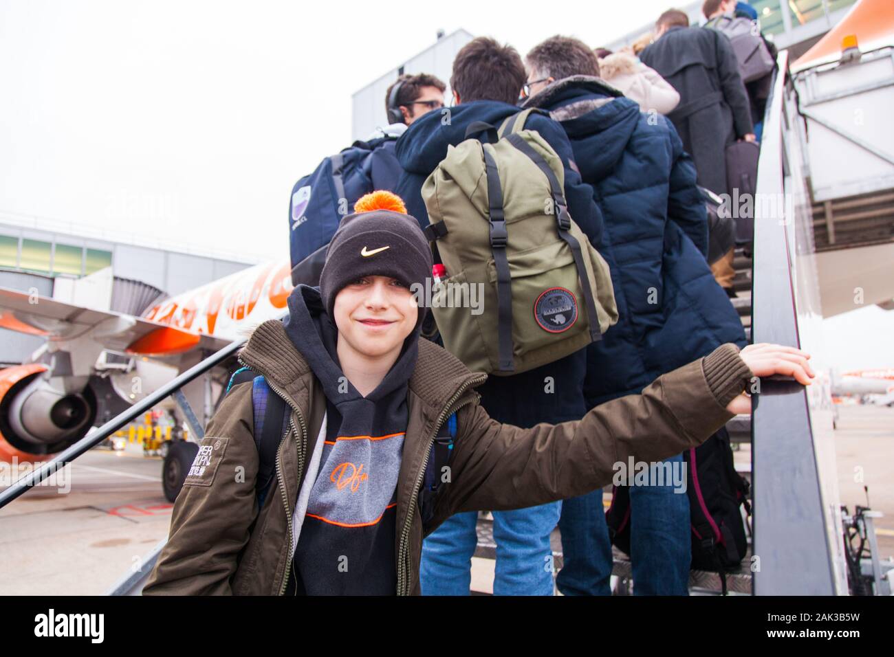 10 year old boy excitedly boarding a Easyjet flight at London Gatwick airport between London Gatwick LGW and Vienna Austria VIE Stock Photo