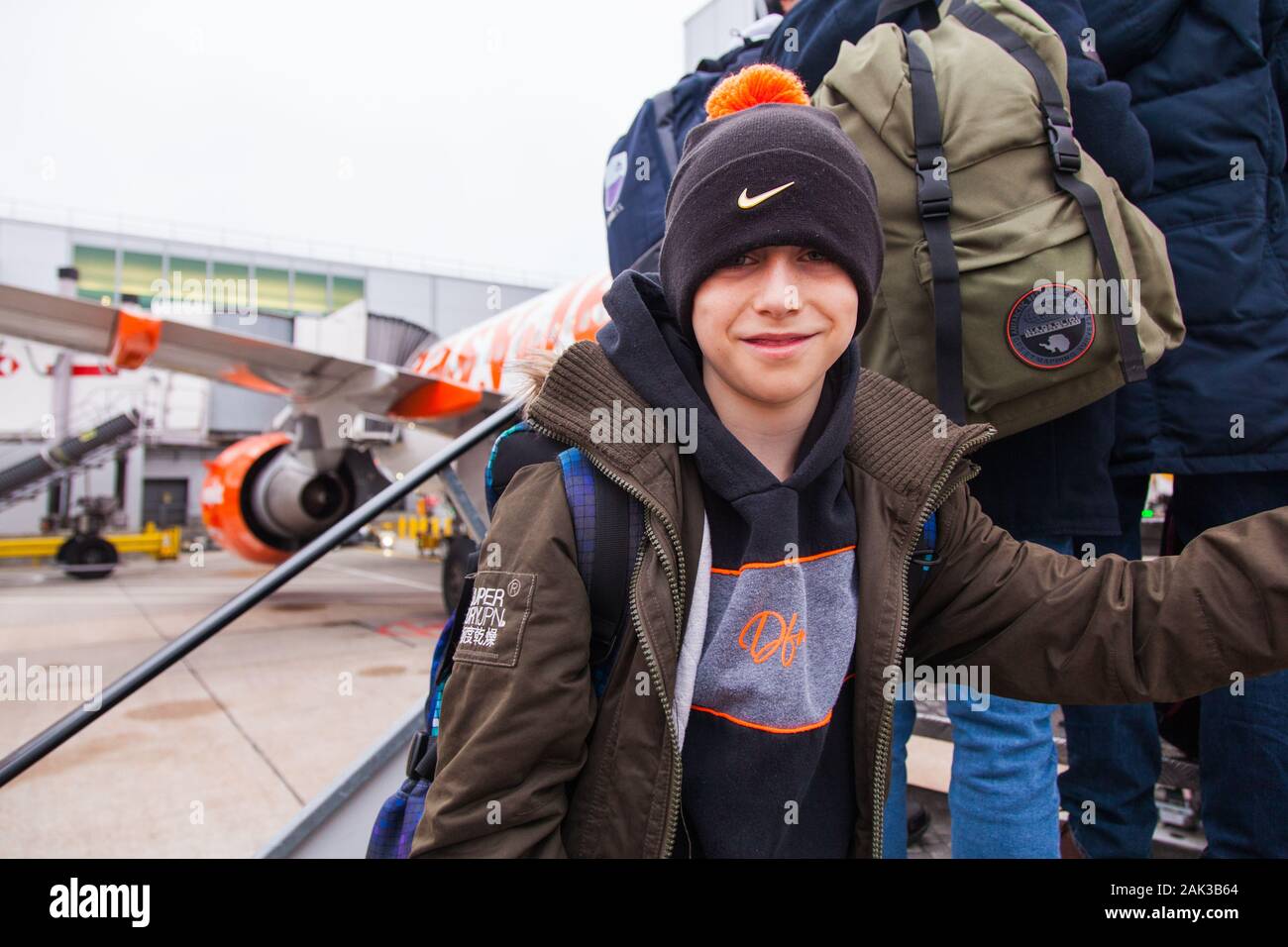 10 year old boy excitedly boarding a Easyjet flight at London Gatwick airport between London Gatwick LGW and Vienna Austria VIE Stock Photo