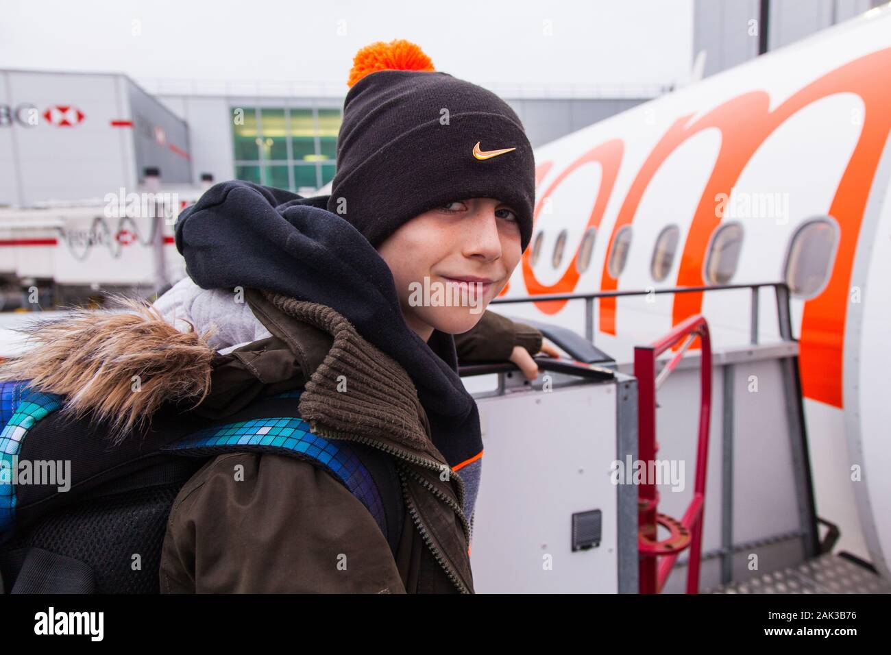 10 year old boy excitedly boarding a Easyjet flight at London Gatwick airport between London Gatwick LGW and Vienna Austria VIE Stock Photo