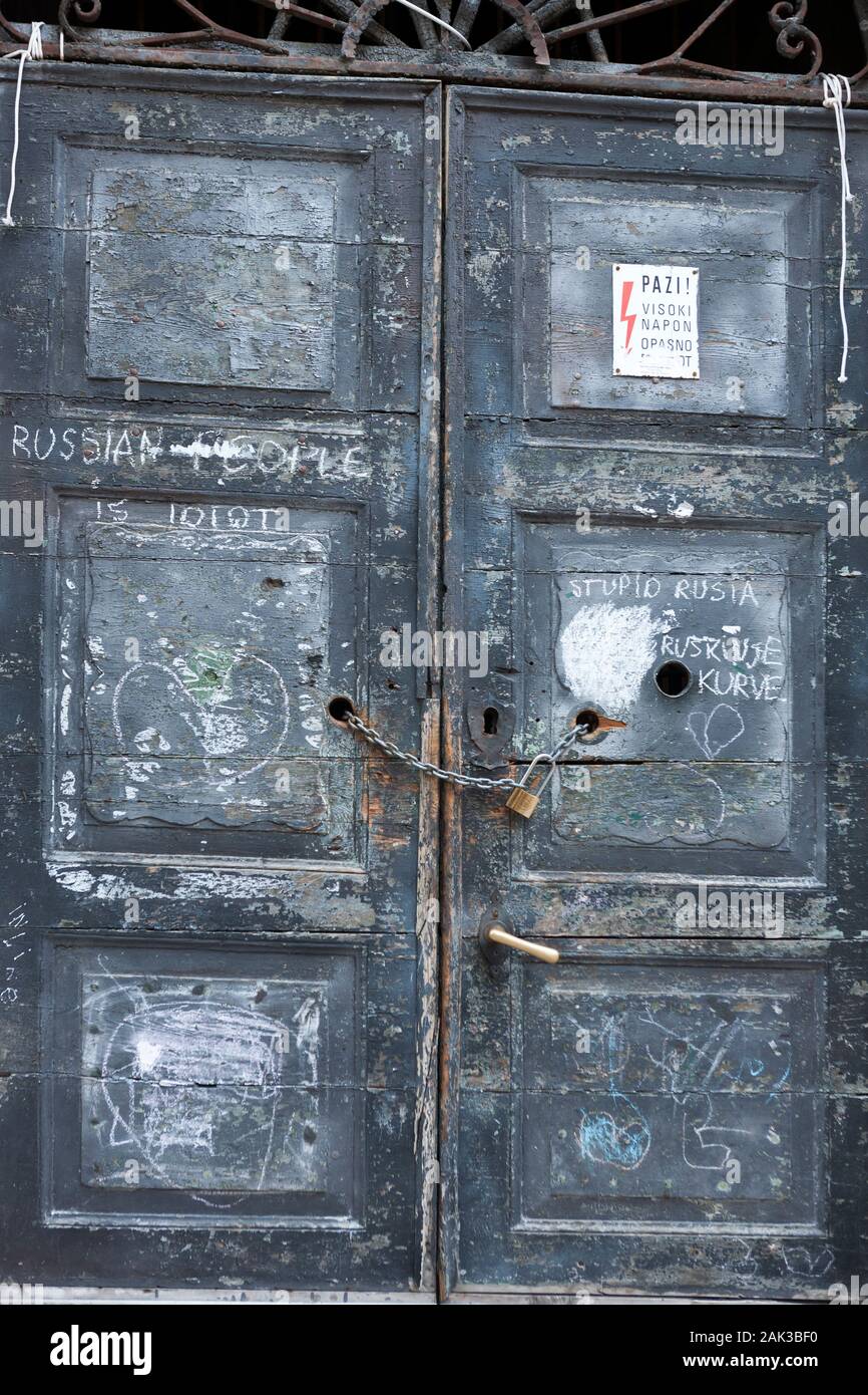 Crude graffiti on a derelict door, Zanatska ulica, Kotor, Montenegro Stock Photo