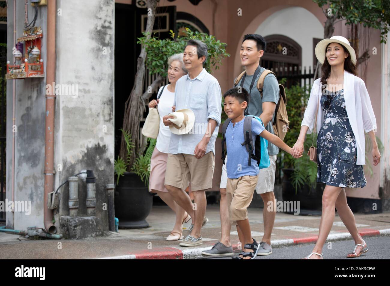Happy Chinese family walking on street Stock Photo - Alamy