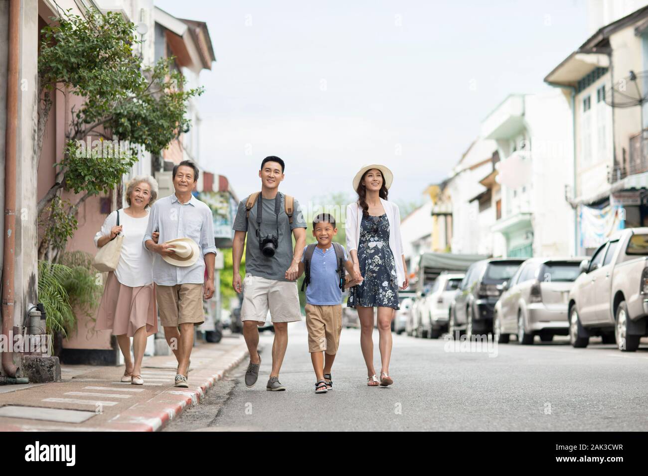 Happy Chinese family walking on street Stock Photo - Alamy