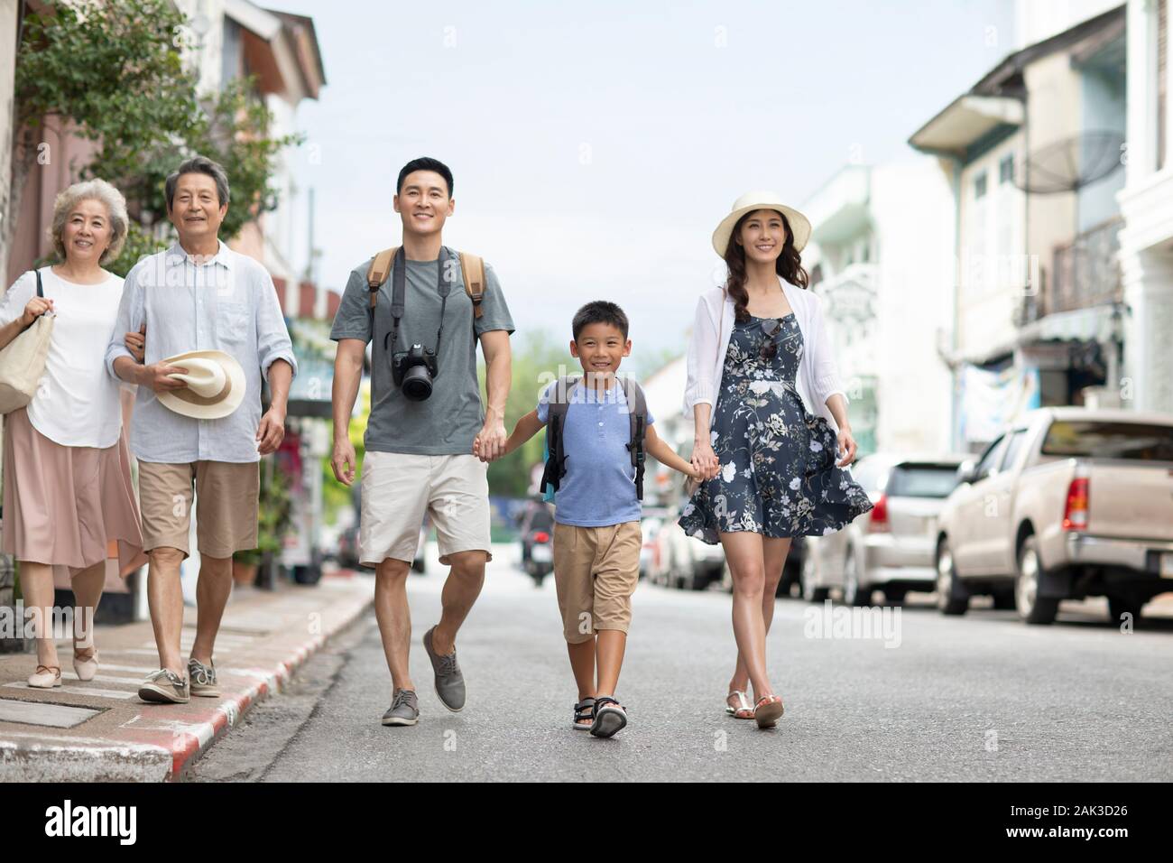 Happy Chinese family walking on street Stock Photo - Alamy