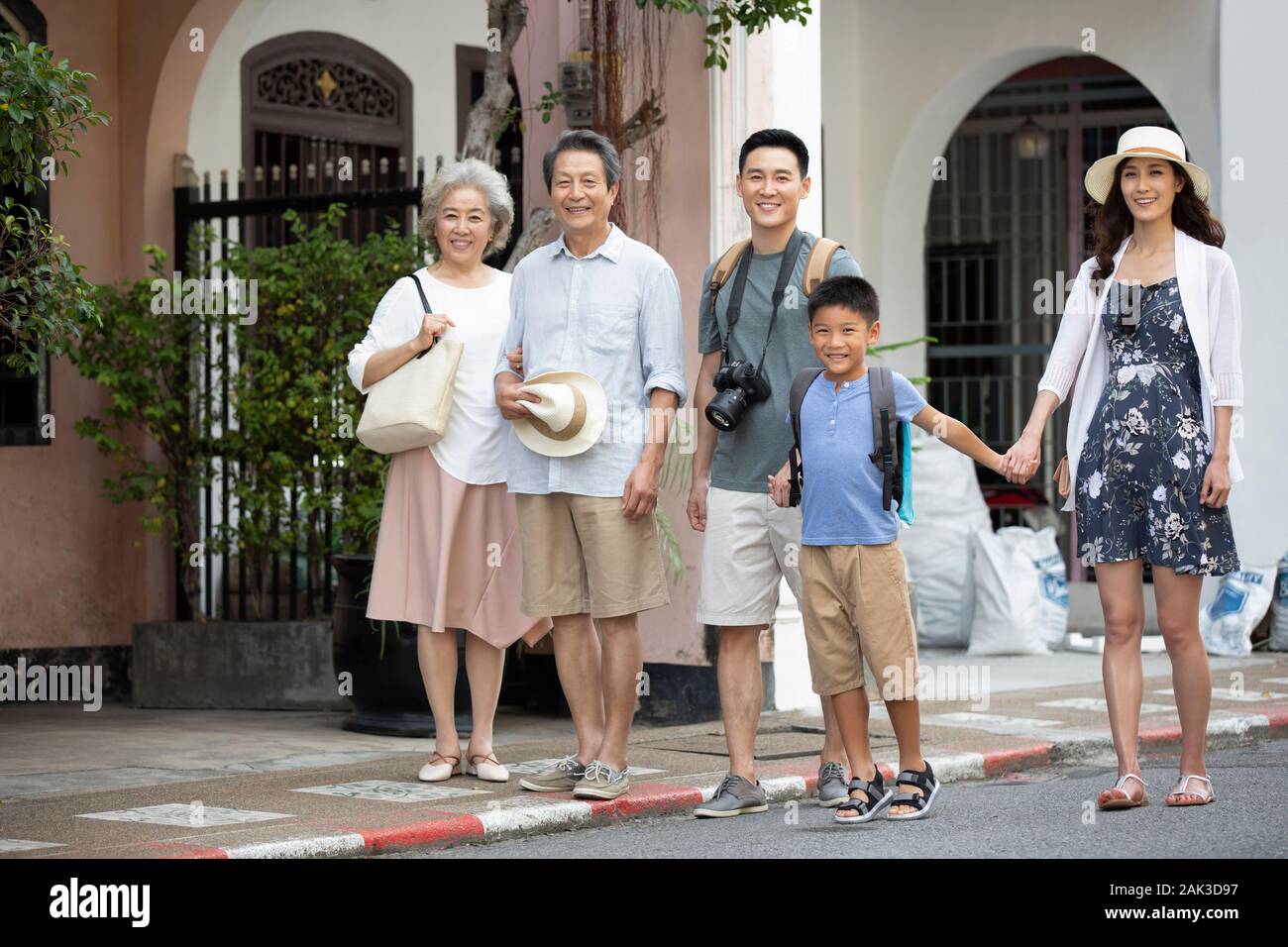 Happy Chinese family standing on street Stock Photo - Alamy