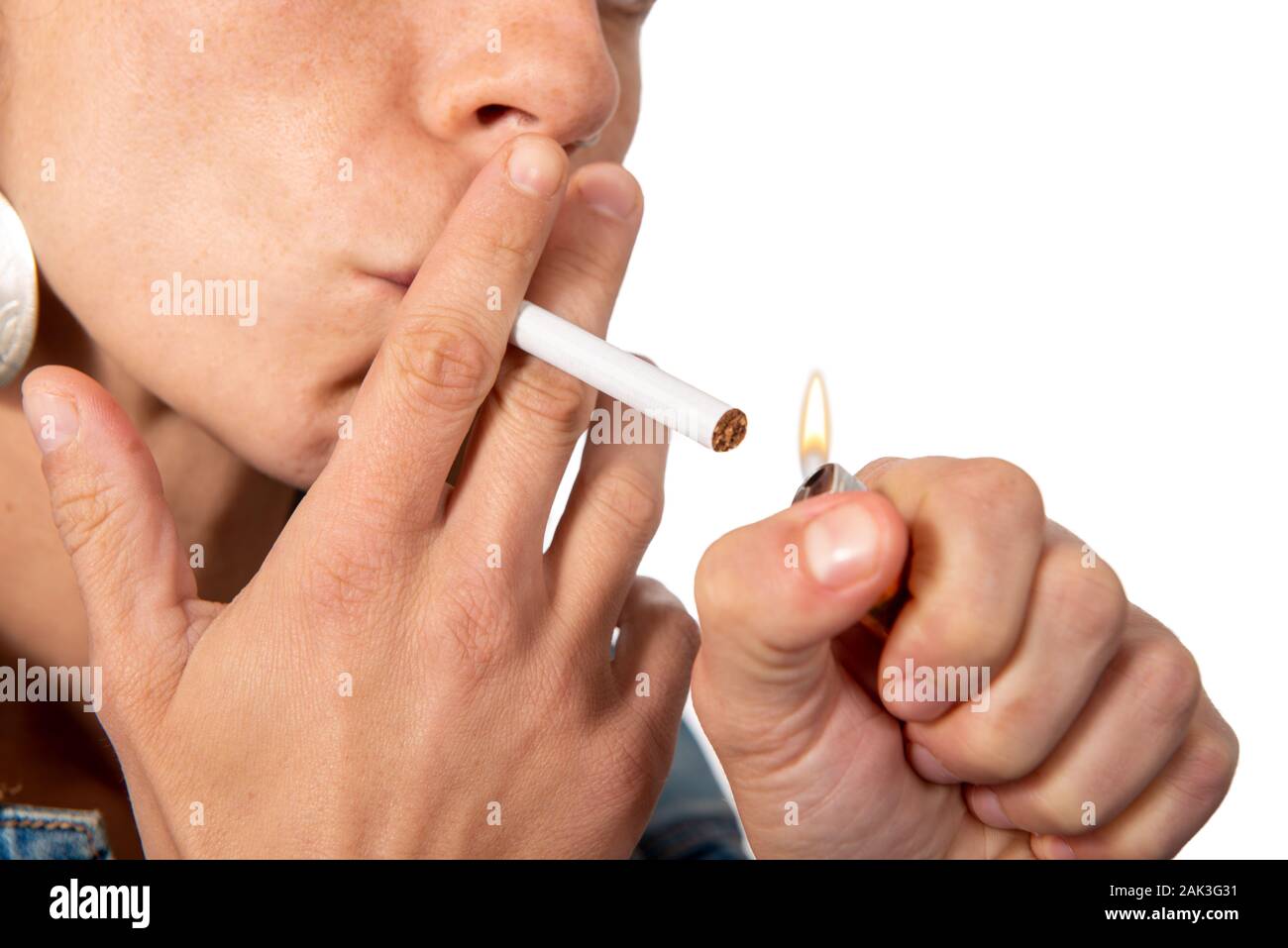 Young woman lighting cigarette isolated on the white background Stock