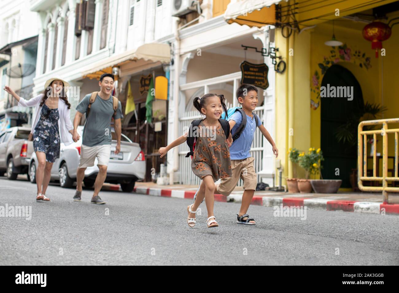 Happy young Chinese family running on street Stock Photo - Alamy