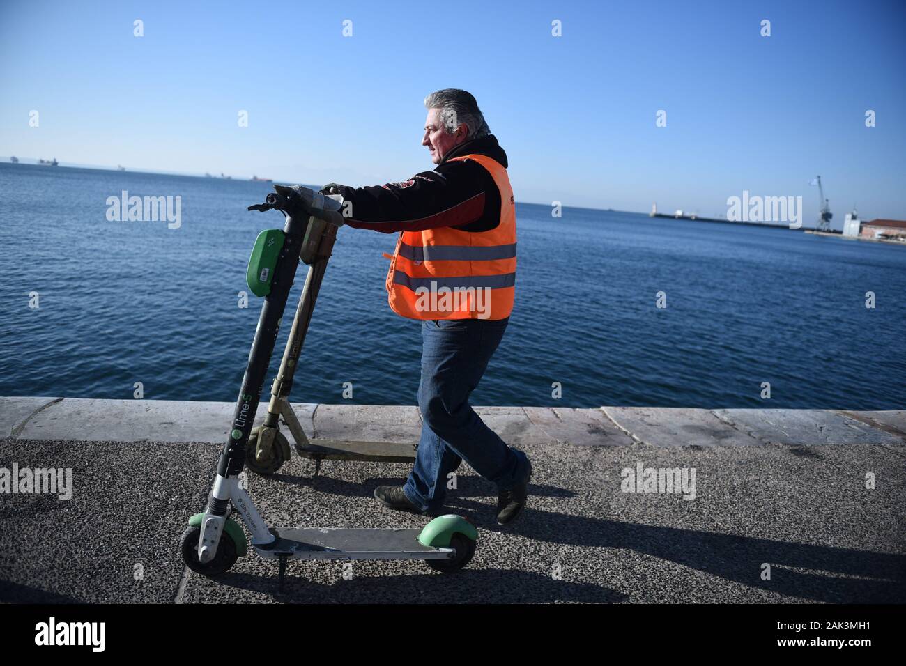 Thessaloniki, Greece. 7th Jan, 2020. An employee of Thessaloniki  Municipality pushes electric scooters after removing them from the sea  bottom. Municipality of Thessaloniki removed electric scooters from the  bottom of the sea,