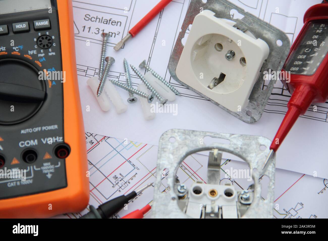 Sockets with a screwdriver and a measuring device on a circuit diagram Stock Photo