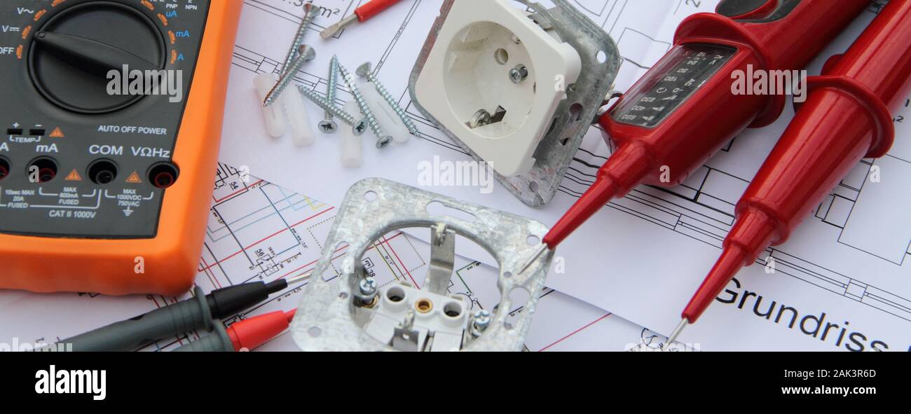 Sockets with a screwdriver and a measuring device on a circuit diagram Stock Photo