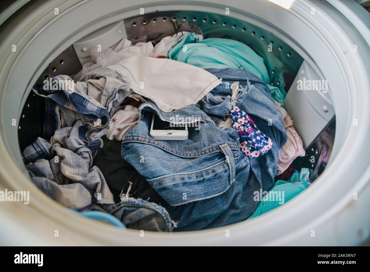 Smartphone in washing machine,Forgotten cell phone in pocket, pant or shirt  Stock Photo - Alamy