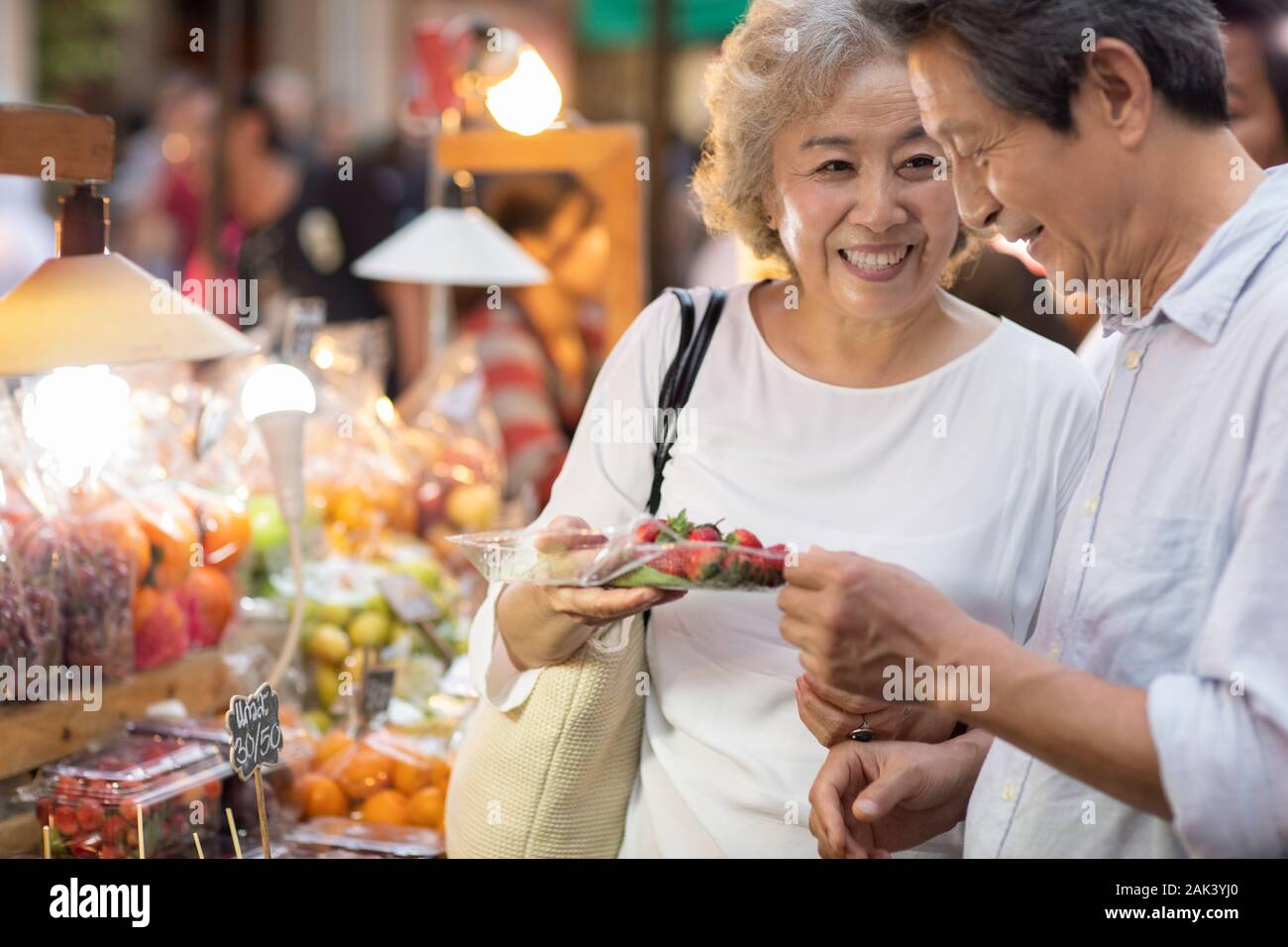 Happy senior Chinese couple relaxing in street market Stock Photo - Alamy