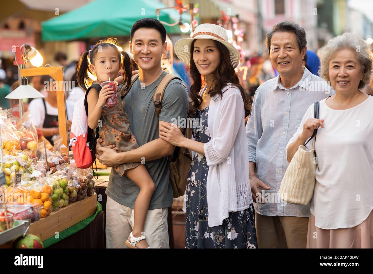 Happy Chinese family relaxing in street market Stock Photo - Alamy