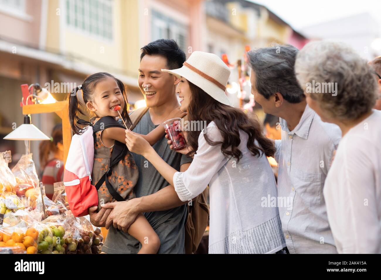 Happy Chinese family relaxing in street market Stock Photo - Alamy