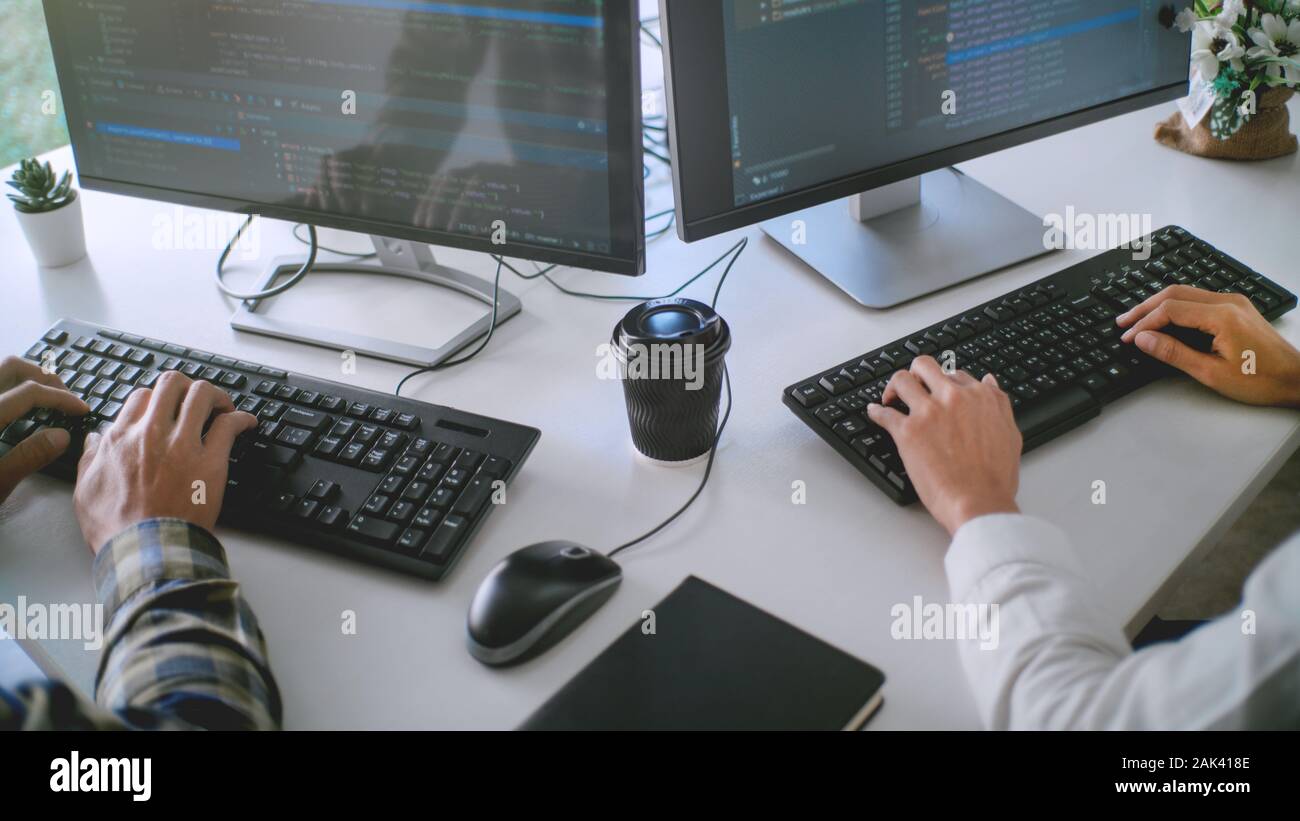 A 4K ultra hd wallpaper of a fox dressed in a computer programmer's outfit,  sitting at a desk with multiple screens and coding with expertise,  portraying a tech-savvy software developer