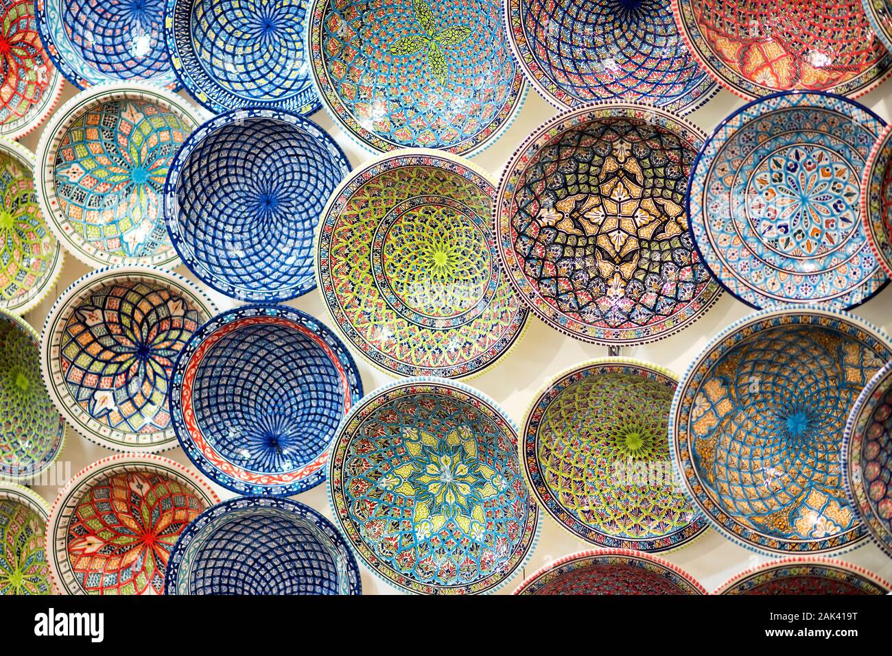 Assortment of decorated glazed handcrafted pottery bowls in different colors and design patterns viewed from above as a full frame background Stock Photo