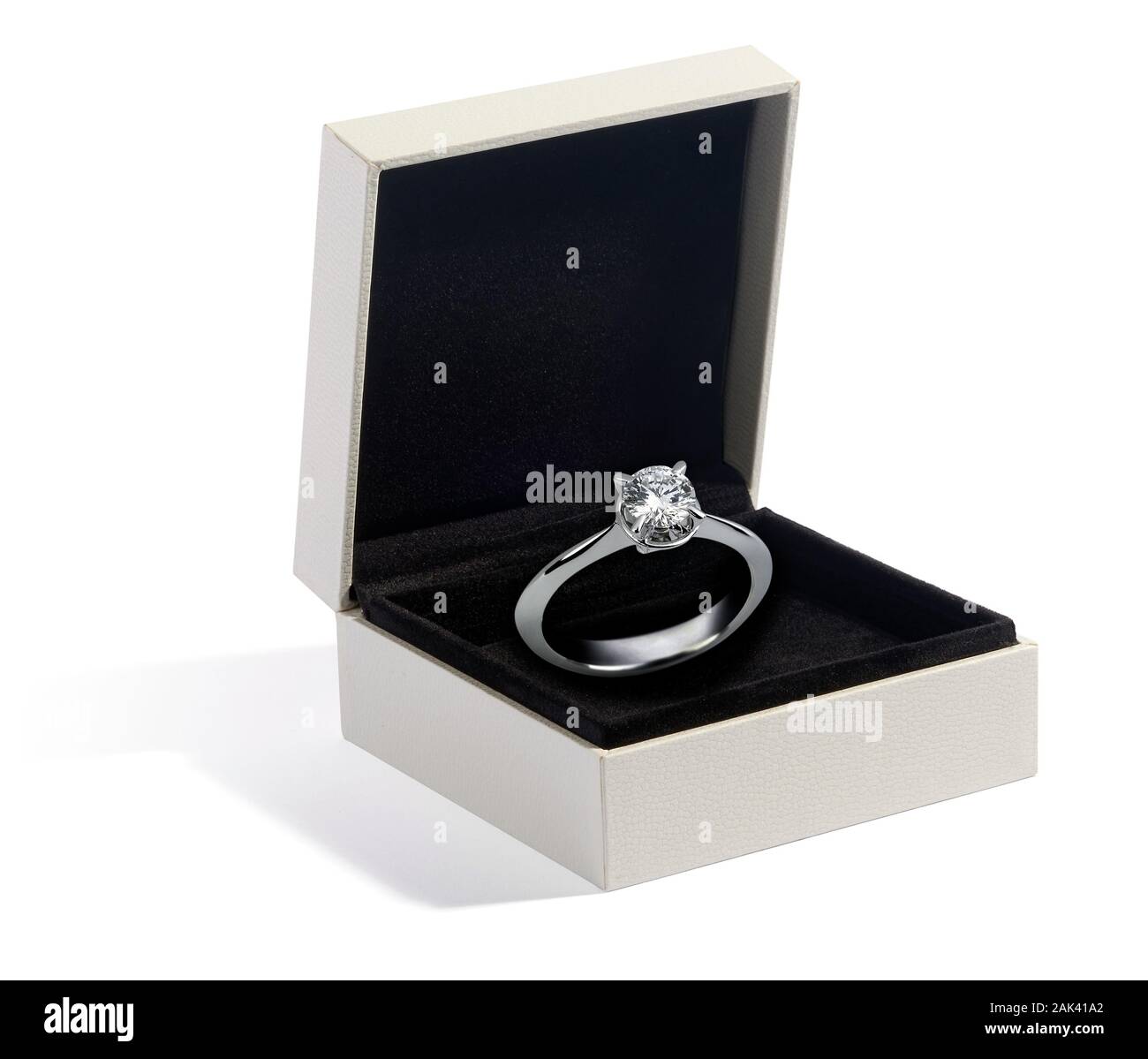 Diamond and white gold or platinum ring displayed in a jewellery box on black velvet as a gift for a loved one, engagement or fashion accessory Stock Photo
