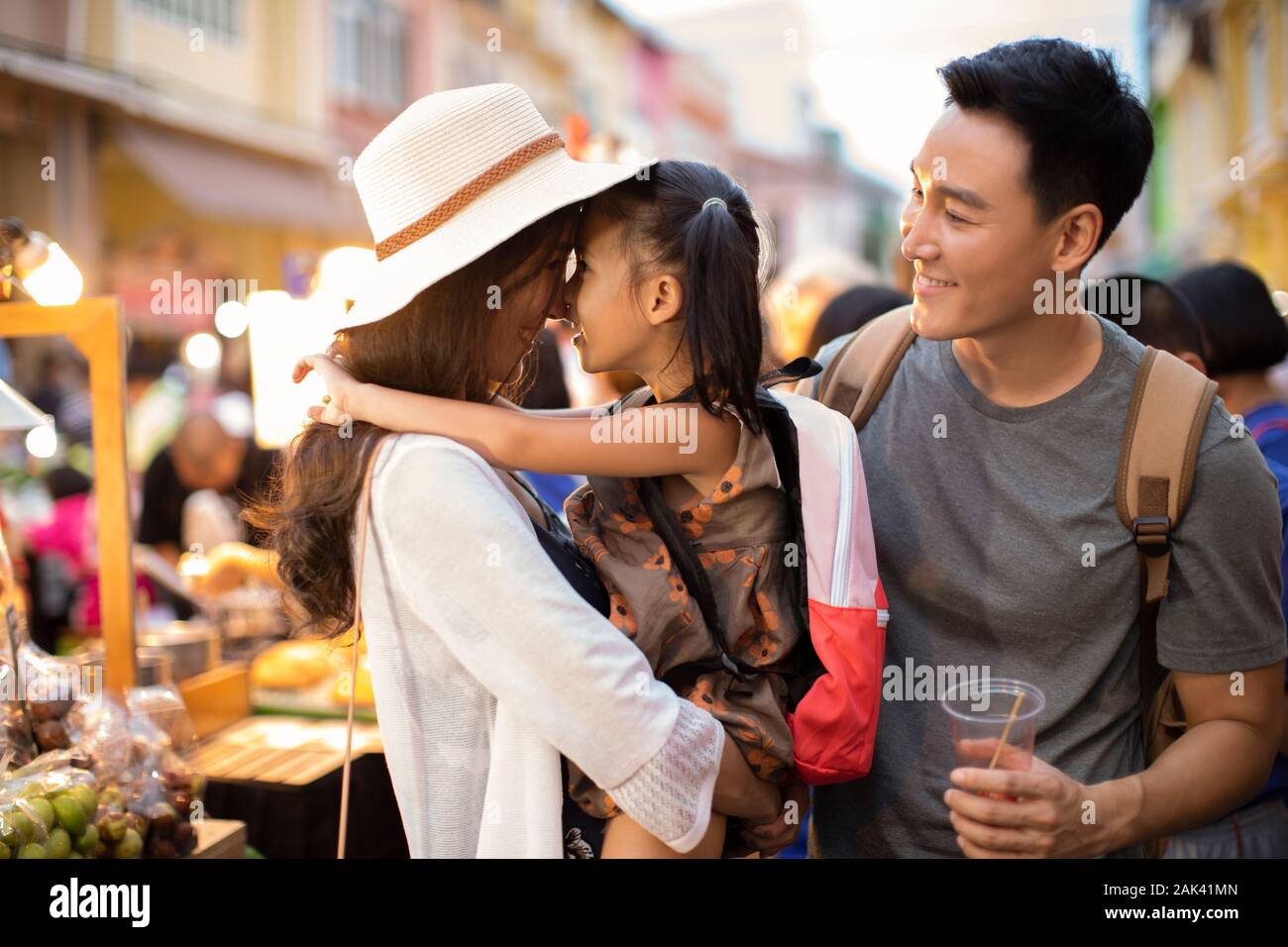 Happy young Chinese family relaxing in street market Stock Photo - Alamy