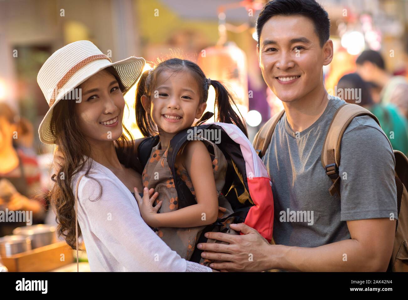 Happy young Chinese family relaxing in street market Stock Photo - Alamy