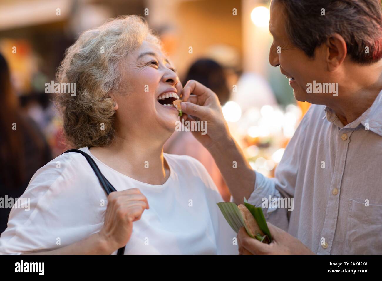 Happy senior Chinese couple relaxing in street market Stock Photo - Alamy
