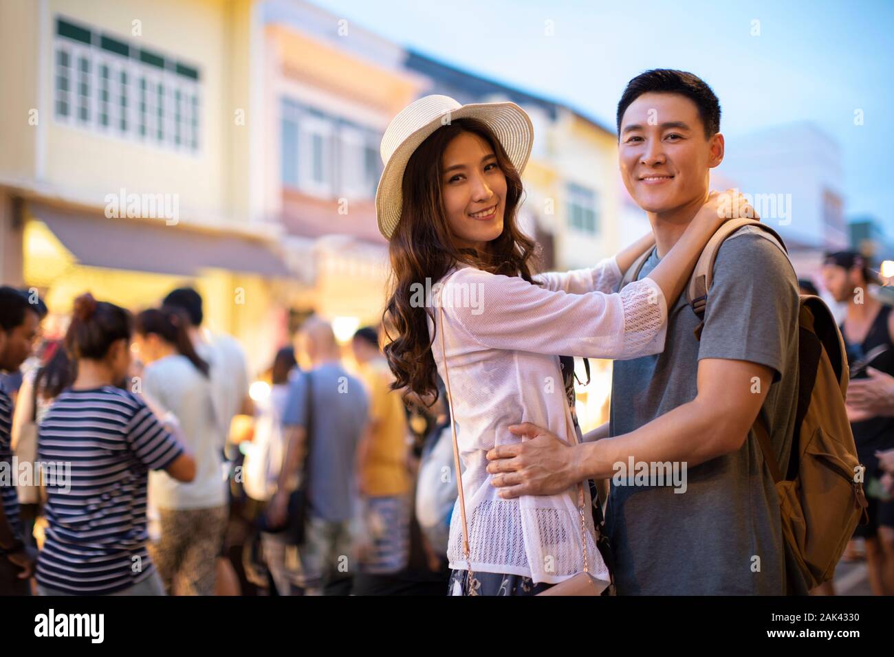 Happy young Chinese couple relaxing in street market Stock Photo - Alamy