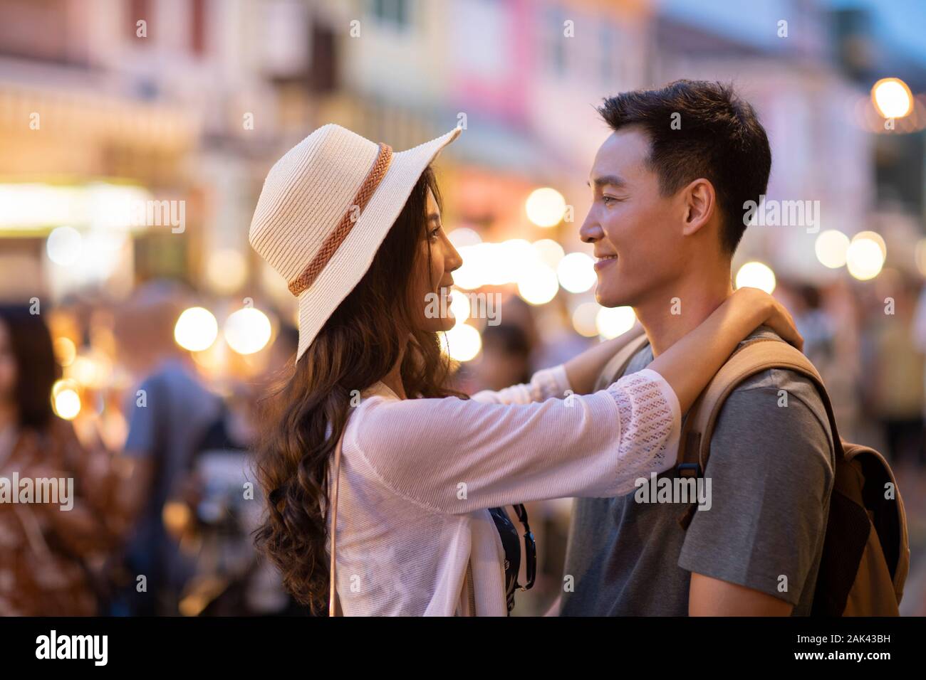 Happy young Chinese couple relaxing in street market Stock Photo - Alamy