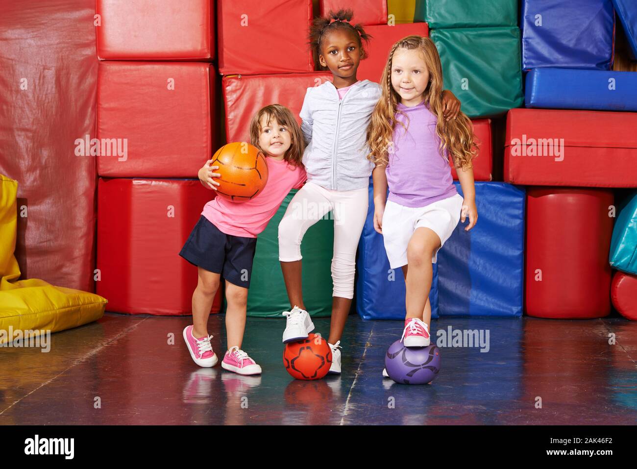Children play together in the gym from kindergarten with balls Stock