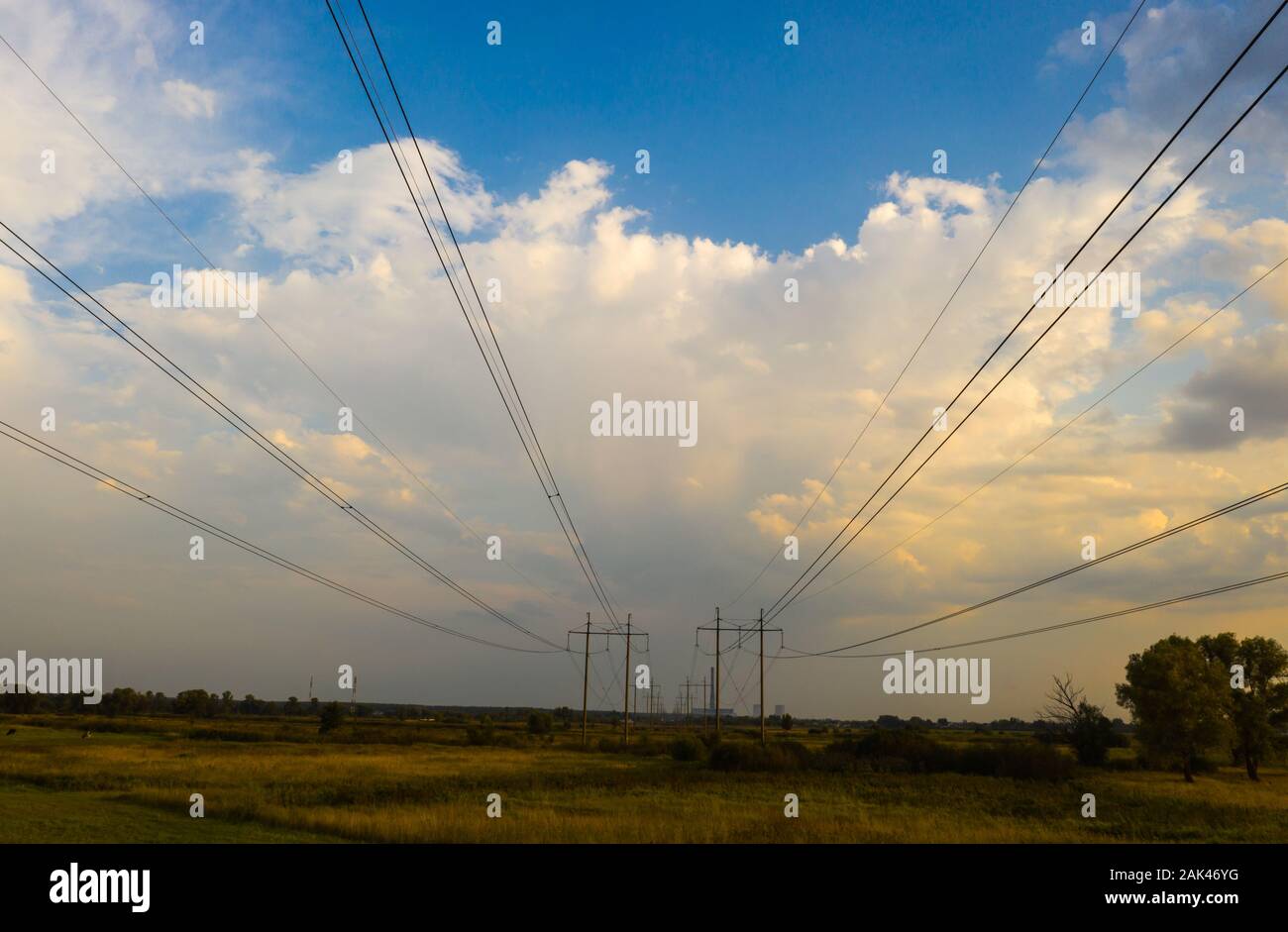 electricity pylons and high voltage power line at sunset Stock Photo ...