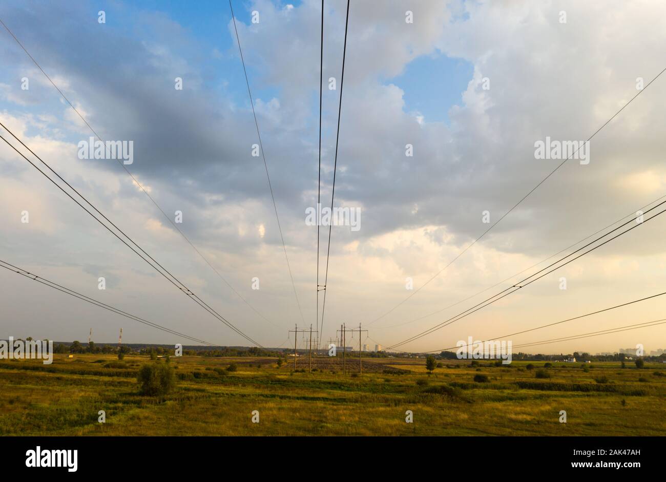 electricity pylons and high voltage power line at sunset Stock Photo ...