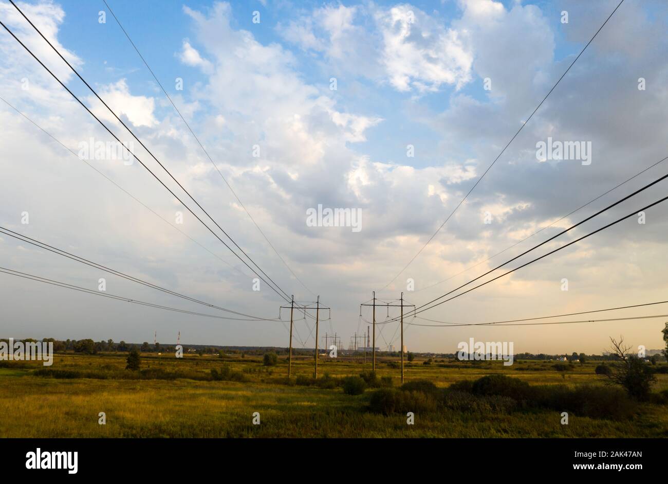 electricity pylons and high voltage power line at sunset Stock Photo ...