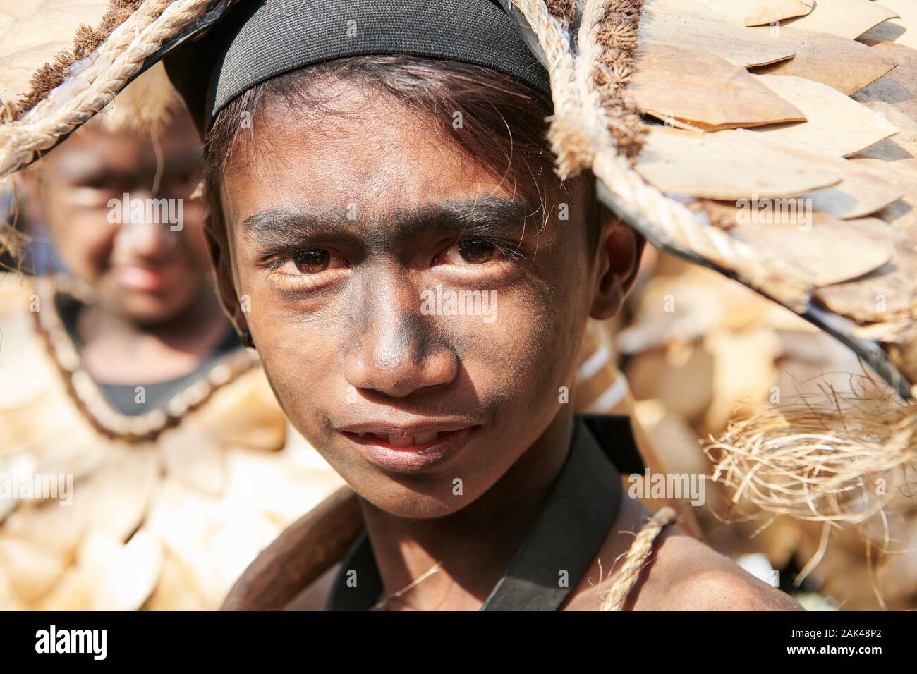 Ibajay Town, Aklan Province, Philippines - January 27, 2019: Portrait of teenage boy in native costume joining the parade at the Ati-Atihan Festival Stock Photo