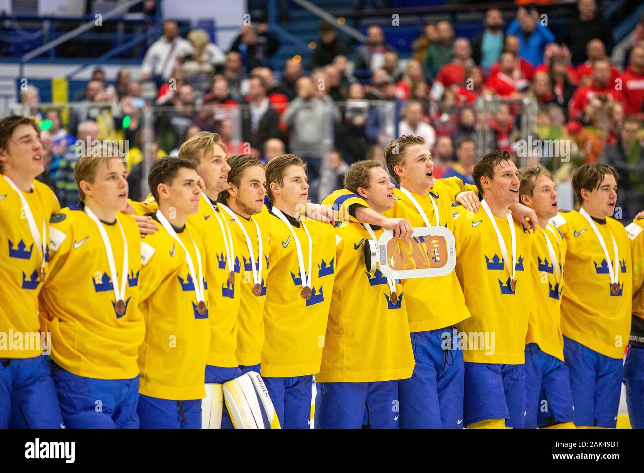 Swedish team's captain Adam Ginning, centre, among his teammates line up with medals after they won the 2020 IIHF World Junior Ice Hockey Championship Stock Photo