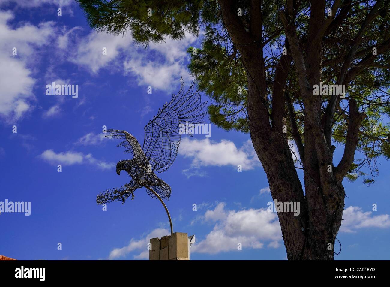 Wire sculpture of a flying eagle by Spiros Mourmouzis of Argostoli  on a marble base at Pastra, Cephalonia, Greece Stock Photo