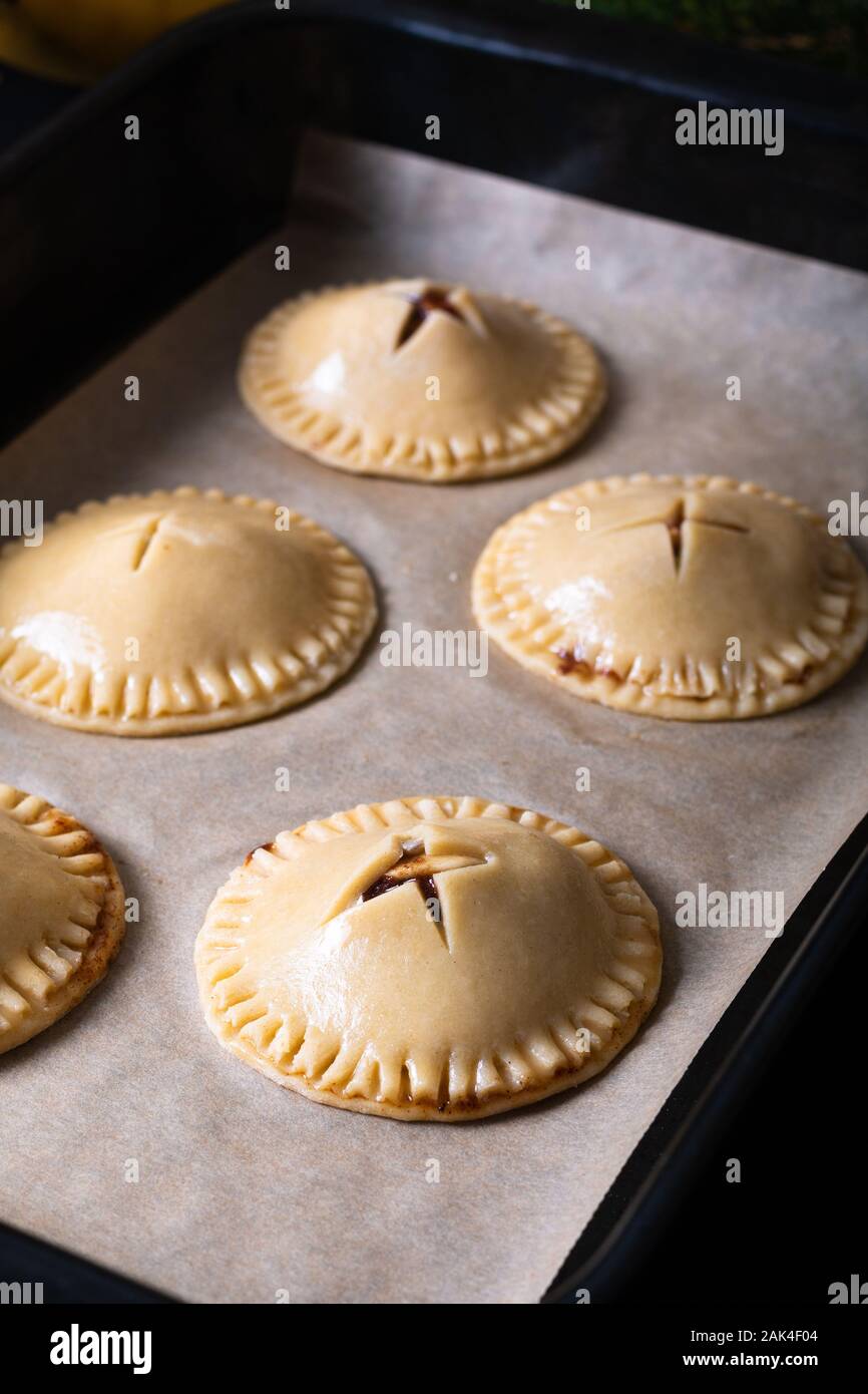 Food concept fresh baked Homemade Banana foster hand pie on black