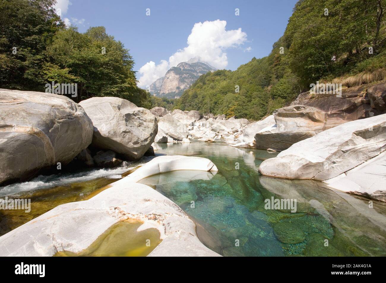 Emerald green the water is gleaming in front of the bizarre rock scenery near Brione in the Valle Verzasca, canton Ticino, Switzerland. (Undated pictu Stock Photo