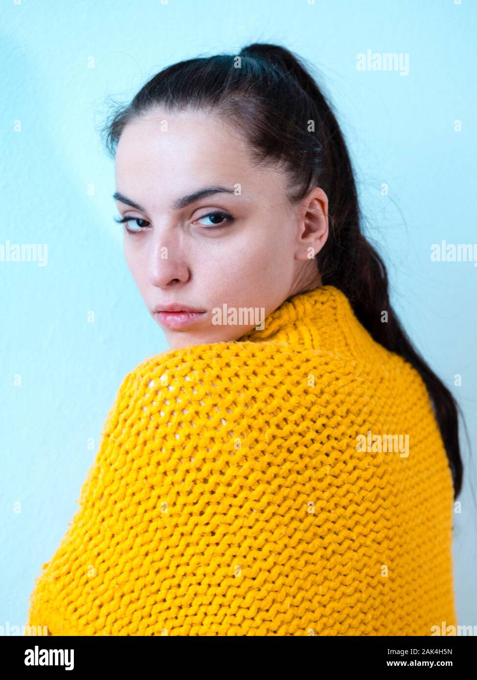 Young woman with yellow pullover, cool look Stock Photo