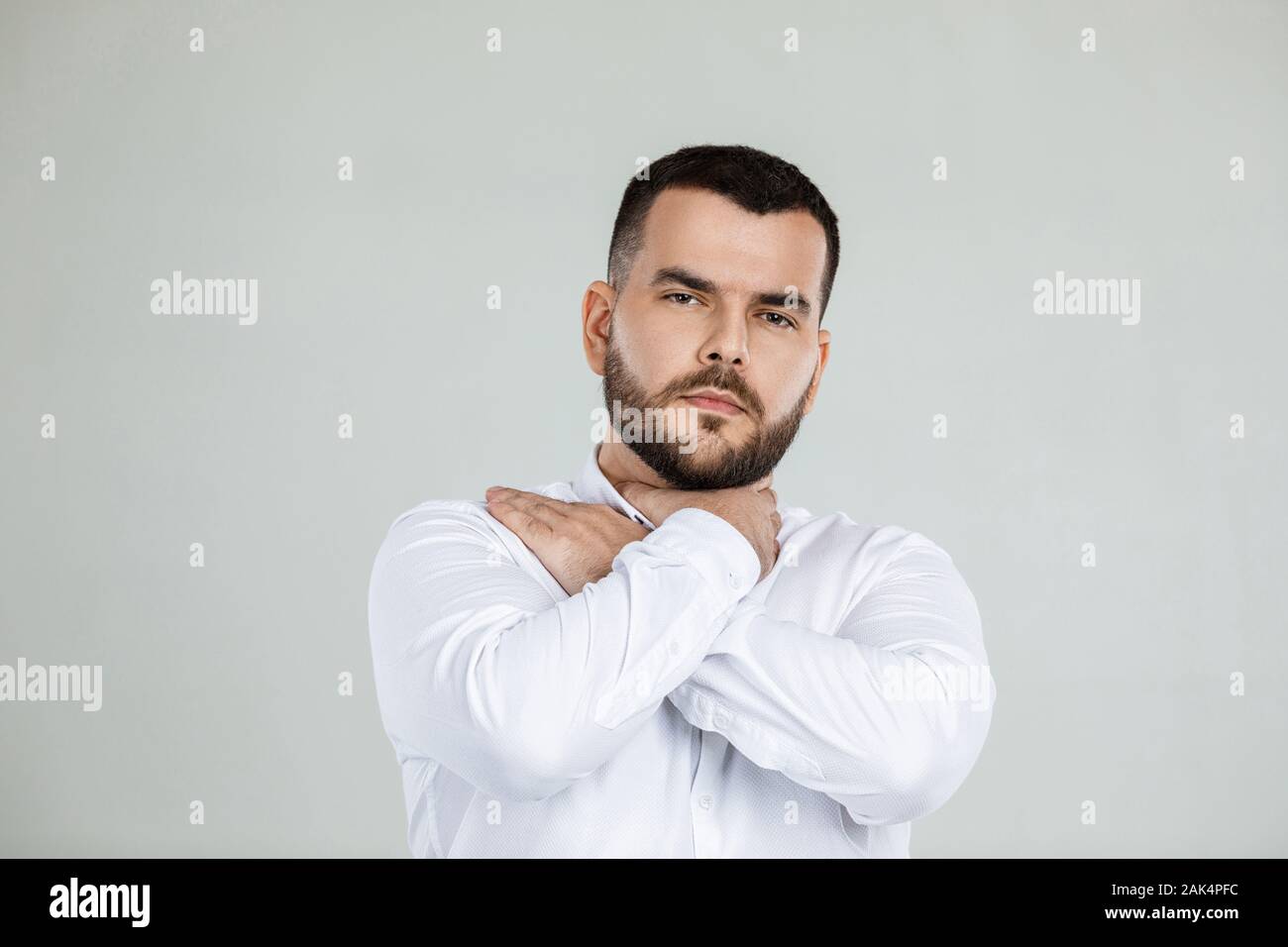 bearded man grabs his throat with both hands , pain in his throat Stock Photo Alamy