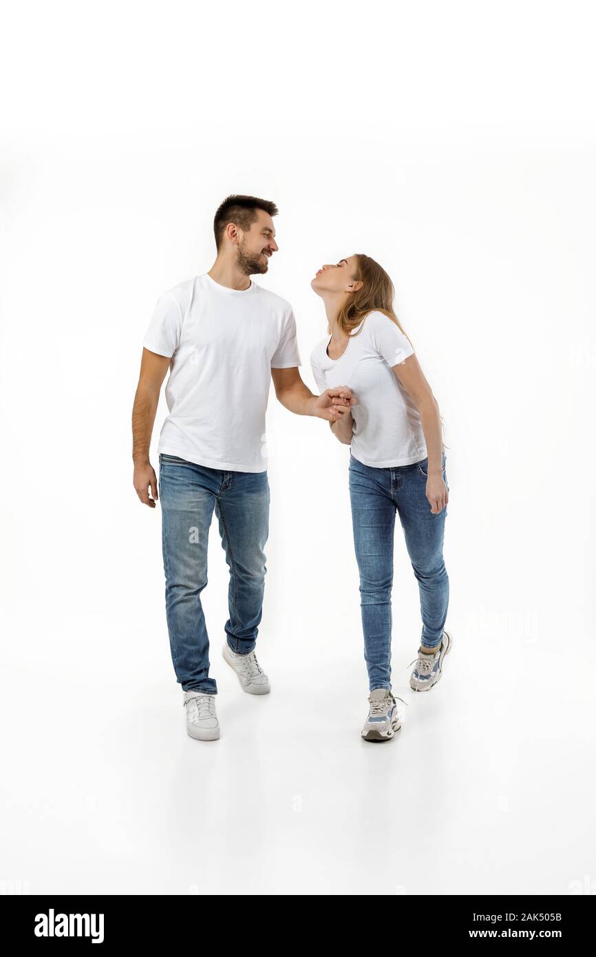 full length portrait of happy couple in casual outfit walking forward ...