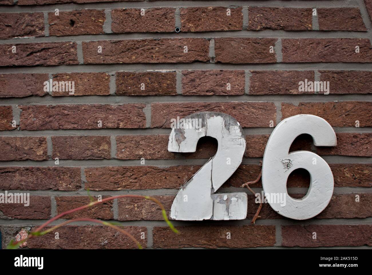 Number 26 on a brick wall Stock Photo