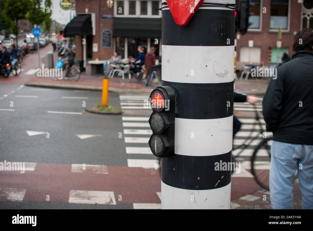 Bicycles on the streets pass by while the traffic light is red Stock Photo