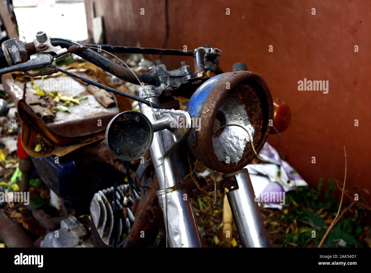 Photo of an old, broken and rusty motorcycle at an empty lot Stock