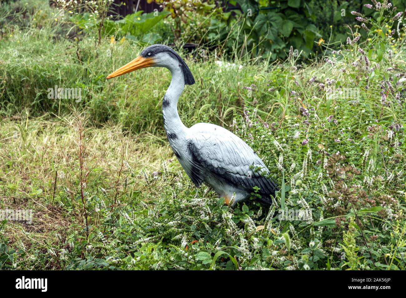 Plastic heron in the garden Germany plastic bird Stock Photo