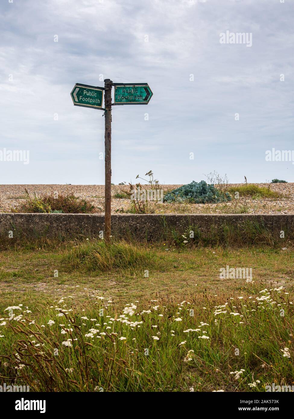 A rusty public footpath sign stands exposed on Climping Beach at Atherington near Littlehampton in Sussex. Stock Photo