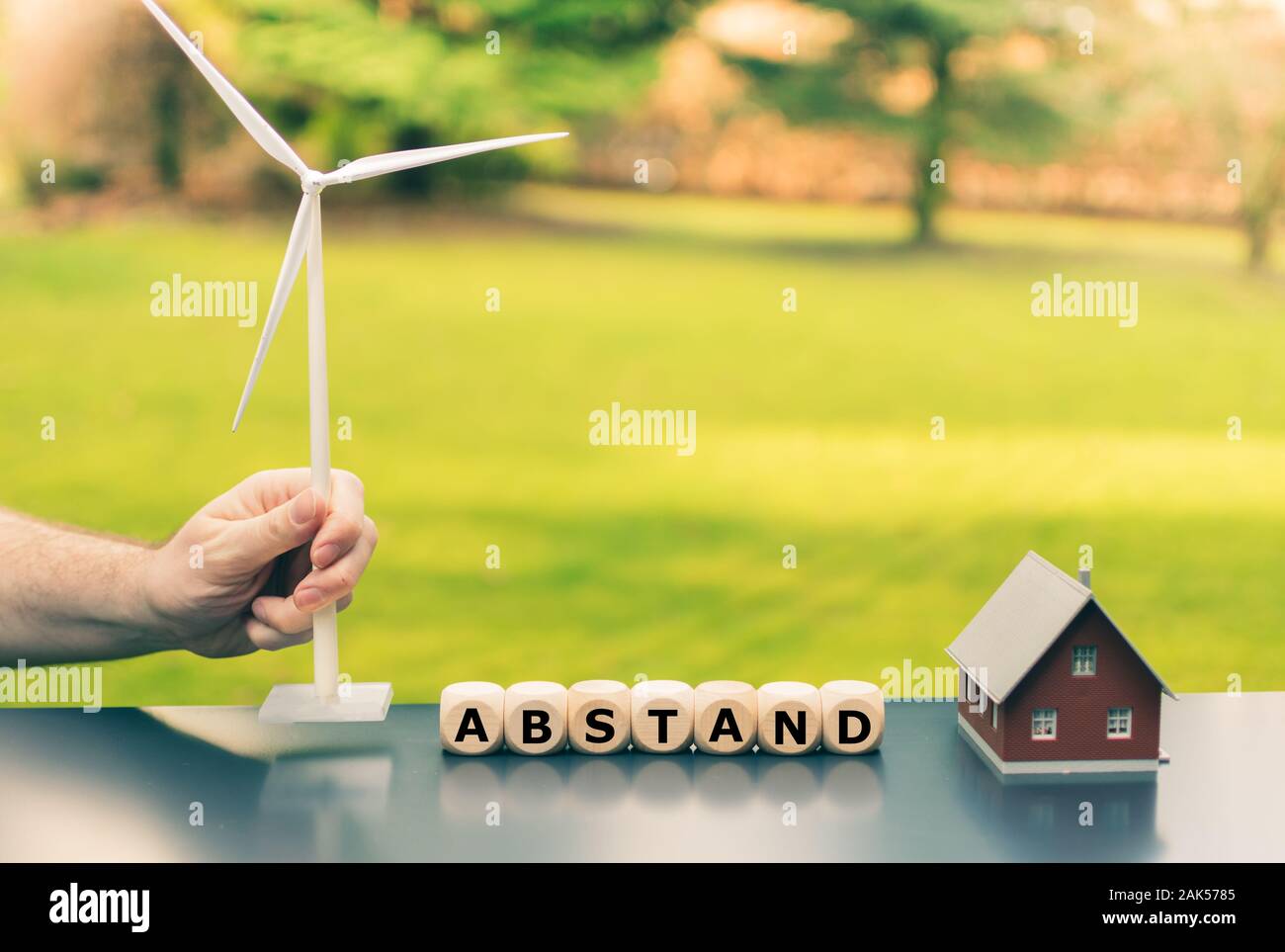 Symbol for a minimum gap ('Abstand' in German) between wind turbines and residential areas. Stock Photo