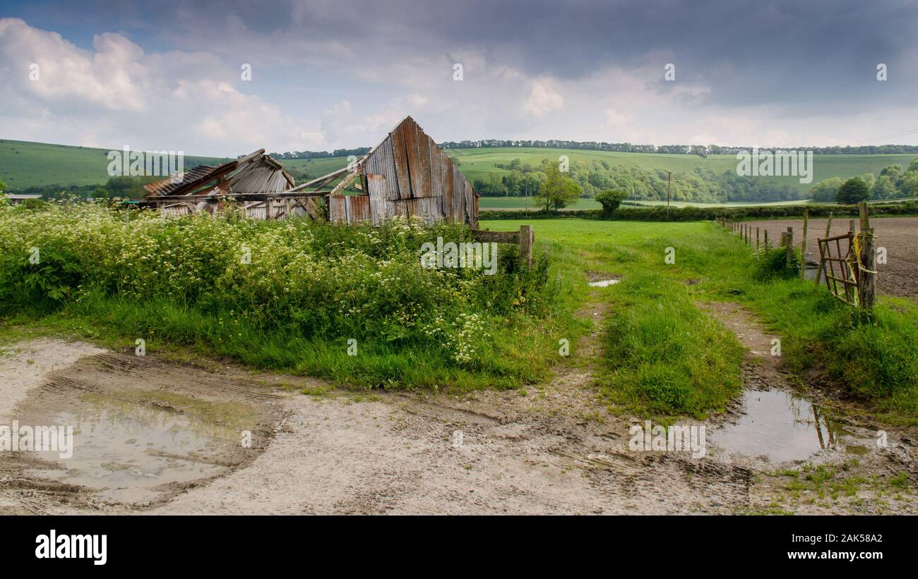 A derelict barn, missing a roof, stands in a field on a farm in the Ebble Valley, nestled under the chalk hills of Cranborne Chase near Salisbury in W Stock Photo