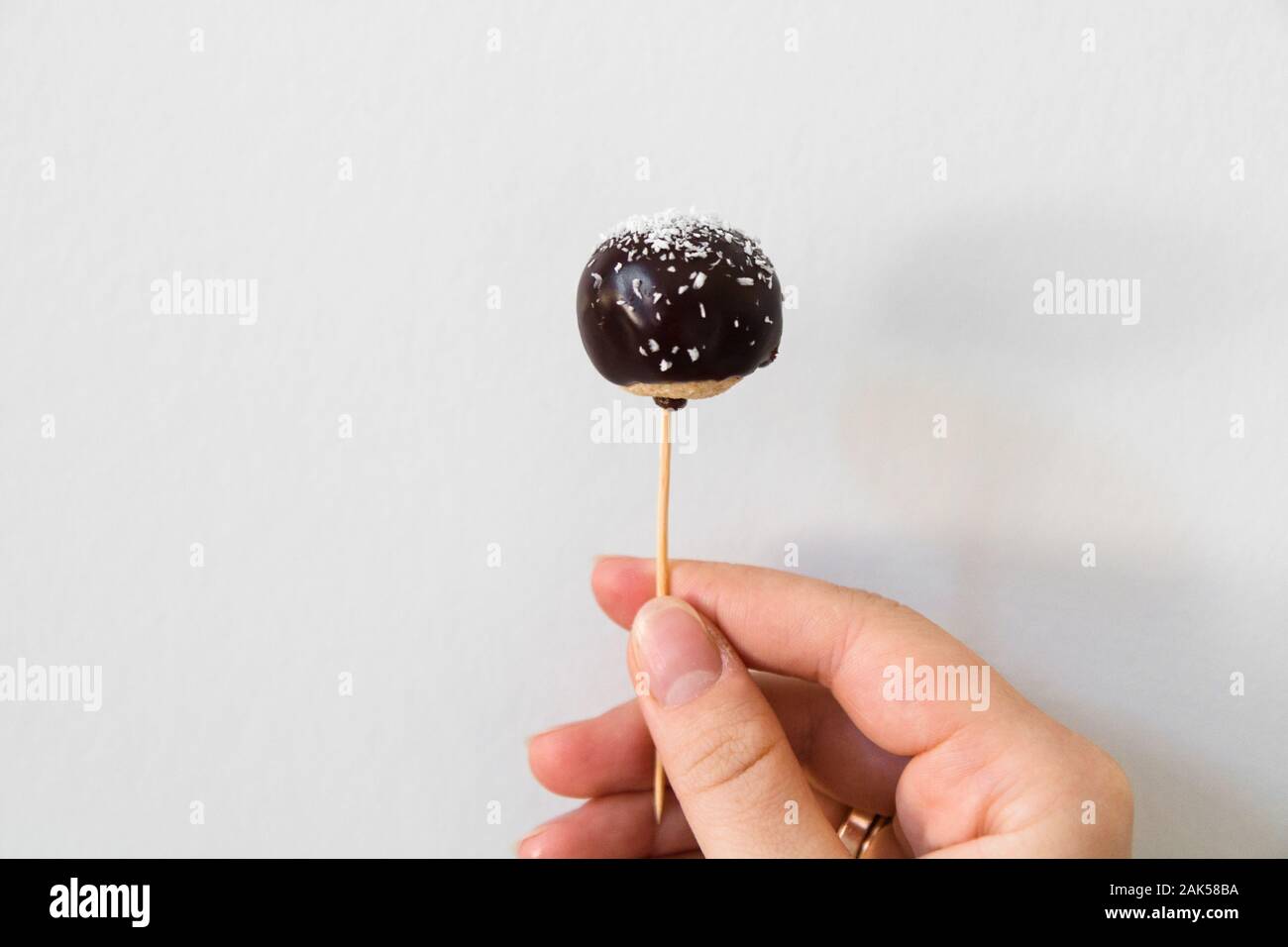 Cake pops candy sticks decorated with dark chocolate. Stock Photo