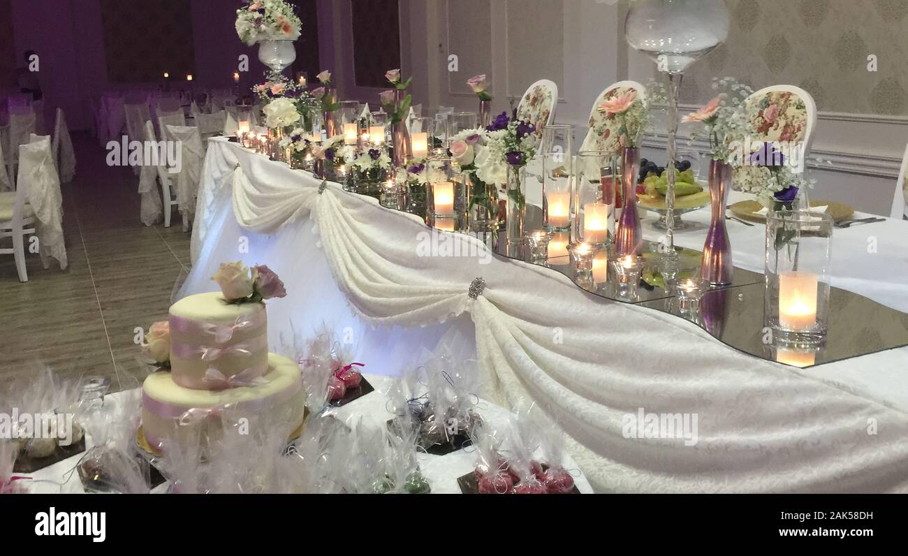 bride and groom table decorated with flowers and candles image Stock Photo