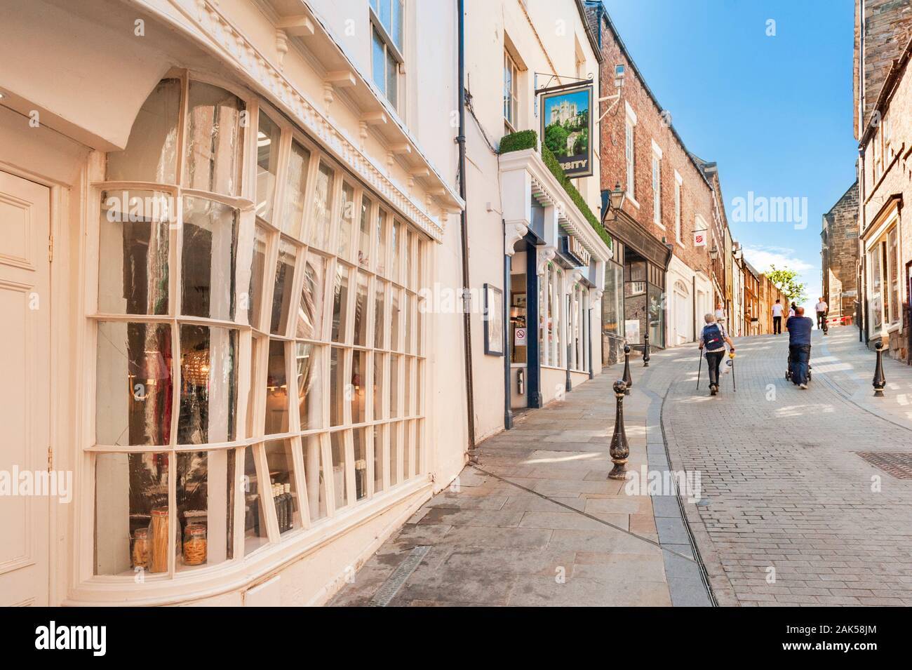 Narrow cobbled road late 18th or early 19th century Grade II listed buildings and old shop frontage Saddler Street Durham Stock Photo