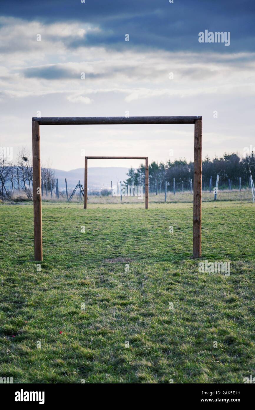 Two wooden soccer goals on green grass field, healthy active lifestyle and new years resolution concept Stock Photo